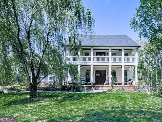 1141 Addington Ln, Waleska, GA 30183 - view of front of property featuring covered porch, ceiling fan, roof with shingles, a balcony, and a front yard