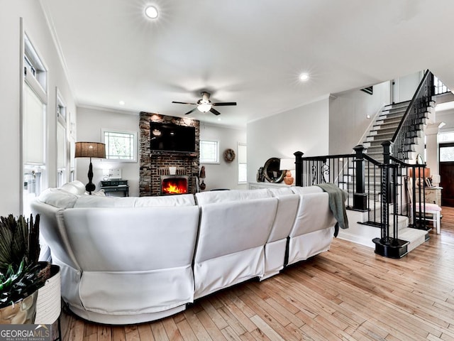 1141 Addington Ln, Waleska, GA 30183 - living room featuring hardwood / wood-style flooring, crown molding, stairway, a fireplace, and a ceiling fan