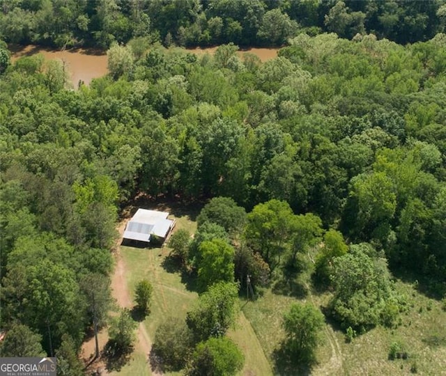 drone / aerial view featuring a wooded view