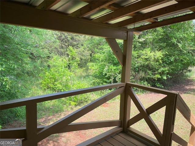 wooden deck featuring a view of trees