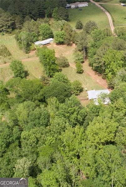 birds eye view of property with a forest view