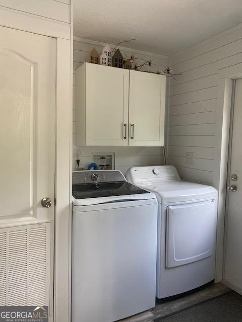 196 SE Stembridge Rd SE, Milledgeville, GA 31061 - laundry area featuring cabinet space, independent washer and dryer, and wooden walls