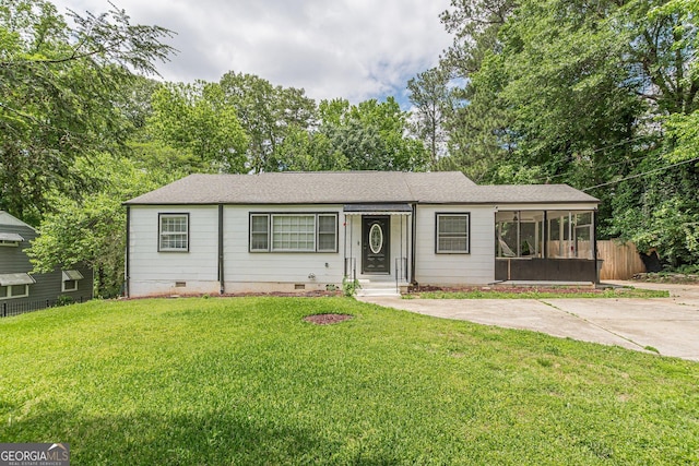 ranch-style house featuring fence, roof with shingles, a sunroom, a front yard, and crawl space