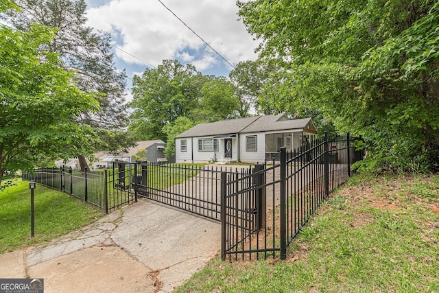 bungalow-style house featuring a fenced front yard, a gate, and a front lawn