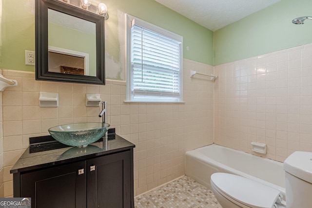 full bathroom featuring tile walls, tile patterned flooring, a wainscoted wall, and toilet