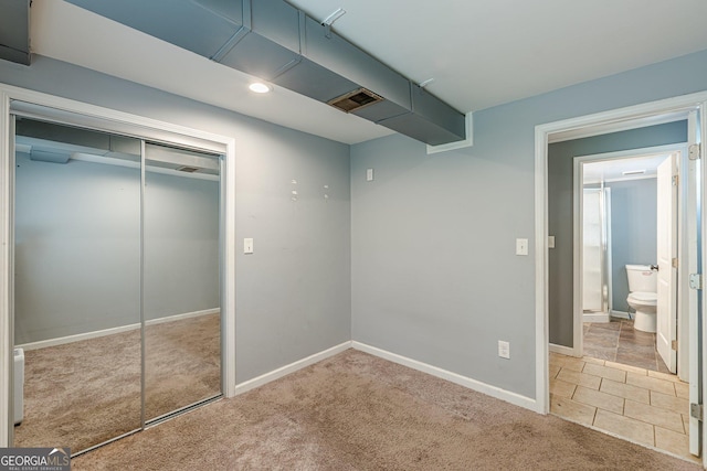 unfurnished bedroom with carpet flooring, recessed lighting, baseboards, and a closet