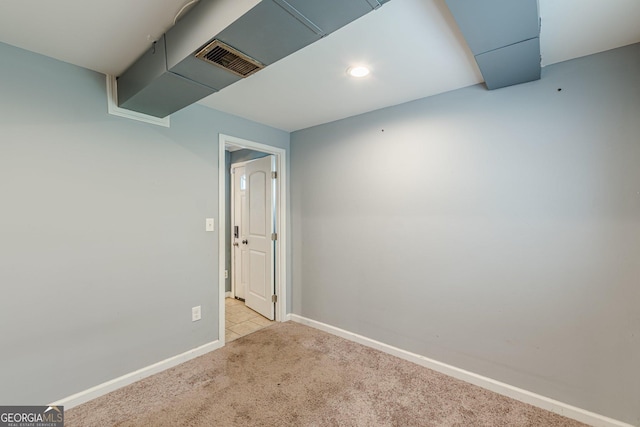 carpeted empty room featuring baseboards, recessed lighting, and visible vents