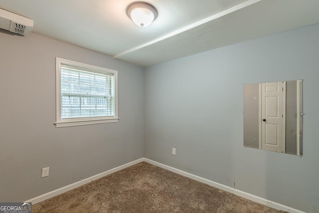 empty room with baseboards and carpet flooring