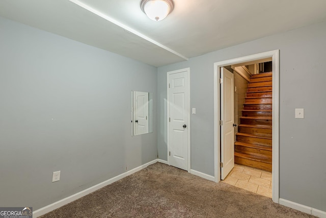 unfurnished bedroom with carpet flooring and baseboards