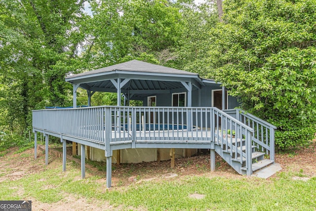 rear view of property featuring a wooden deck