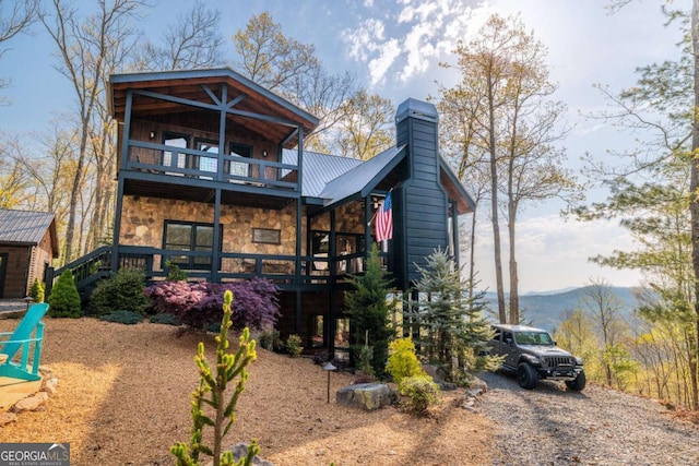194 Blue Sky Overlook, Blue Ridge, GA 30513 - back of house featuring a balcony, metal roof, a mountain view, stone siding, and a chimney