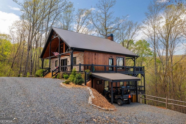 283 Blue Sky Overlook, Blue Ridge, GA 30513 - exterior space featuring metal roof, stone siding, a chimney, a deck, and fence