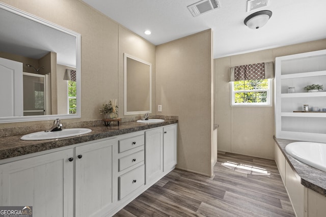 1173 N Ga Highway 21, Springfield, GA 31329 - bathroom featuring double vanity, a bath, wood finished floors, and a shower with shower door
