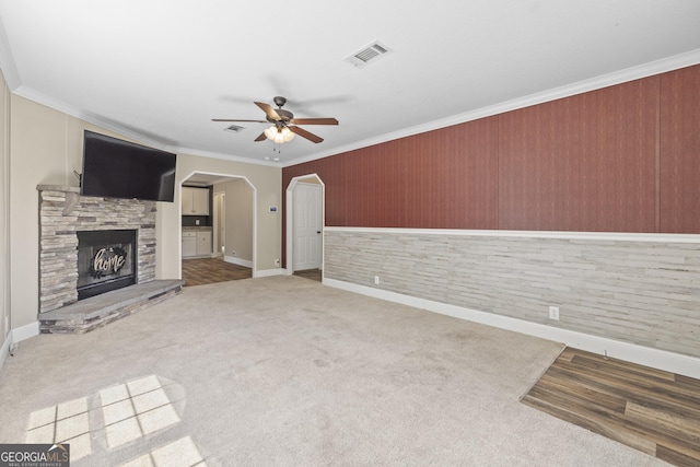 1173 N Ga Highway 21, Springfield, GA 31329 - unfurnished living room featuring ceiling fan, crown molding, carpet flooring, arched walkways, and a fireplace