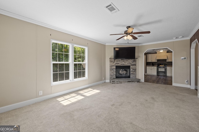 1173 N Ga Highway 21, Springfield, GA 31329 - unfurnished living room featuring ornamental molding, dark colored carpet, ceiling fan, a fireplace, and arched walkways