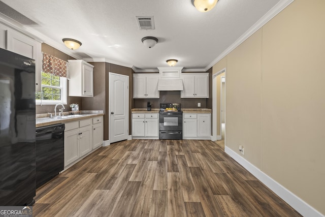 1173 N Ga Highway 21, Springfield, GA 31329 - kitchen with black appliances, custom range hood, crown molding, dark wood-style flooring, and white cabinets