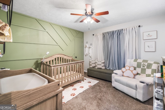 bedroom featuring carpet floors, a textured ceiling, and ceiling fan