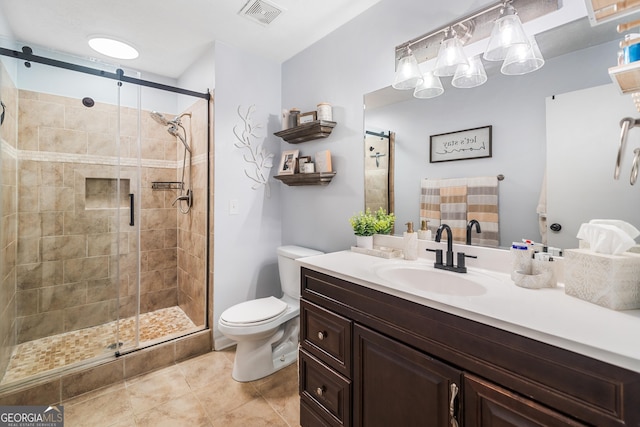 bathroom with visible vents, tile patterned flooring, a shower stall, vanity, and toilet