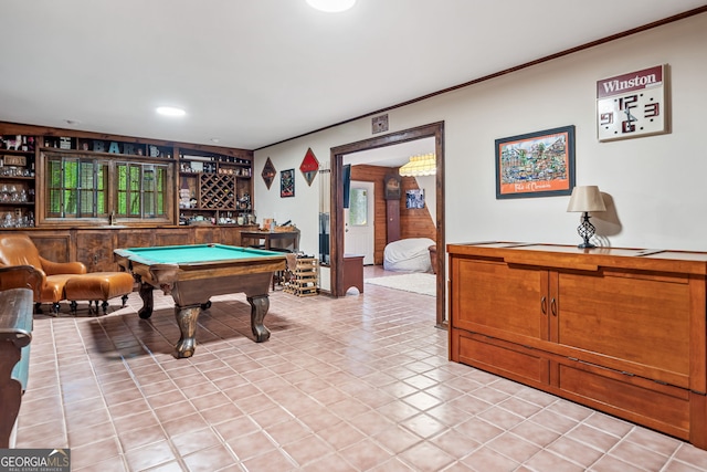 game room featuring pool table, a dry bar, ornamental molding, and light tile patterned flooring