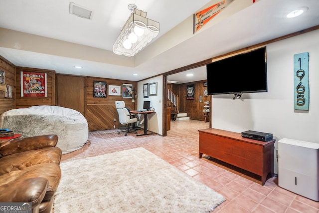 living area featuring recessed lighting, wood walls, light tile patterned flooring, and visible vents