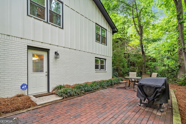 view of patio with outdoor dining space and a grill