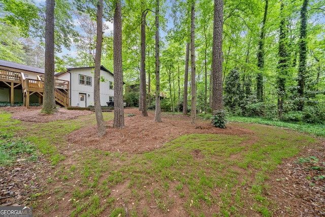 view of yard featuring stairs and a wooden deck