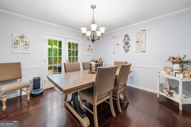 dining space featuring crown molding, baseboards, a notable chandelier, and dark wood-style floors