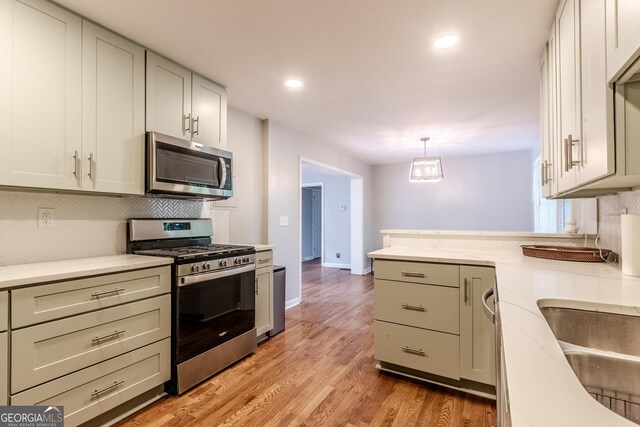 2174 Beecher Rd SW, Atlanta, GA 30311 - kitchen featuring light countertops, appliances with stainless steel finishes, and decorative backsplash