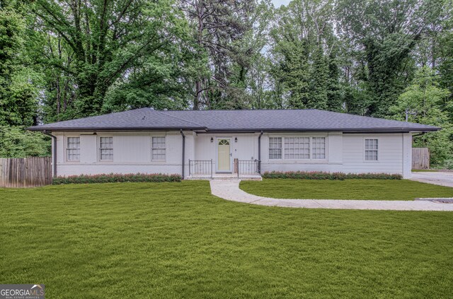 2174 Beecher Rd SW, Atlanta, GA 30311 - ranch-style house featuring a shingled roof, brick siding, fence, and a front yard
