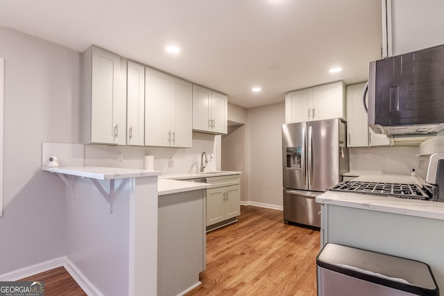 2174 Beecher Rd SW, Atlanta, GA 30311 - kitchen with light countertops, stainless steel appliances, tasteful backsplash, and a breakfast bar area