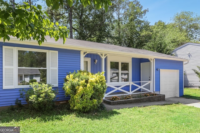 single story home featuring covered porch, a garage, a front yard, and driveway