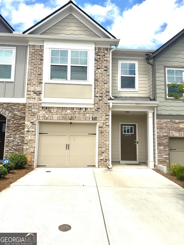 multi unit property with concrete driveway and a garage