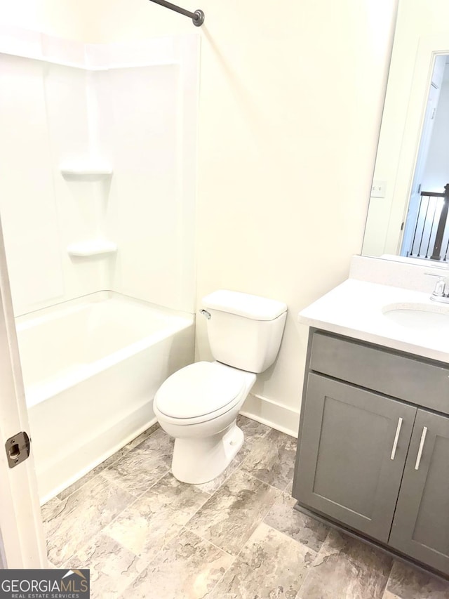 bathroom with toilet, baseboards, bathing tub / shower combination, and vanity