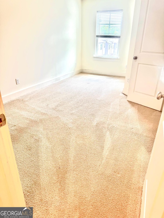 spare room with carpet floors and baseboards