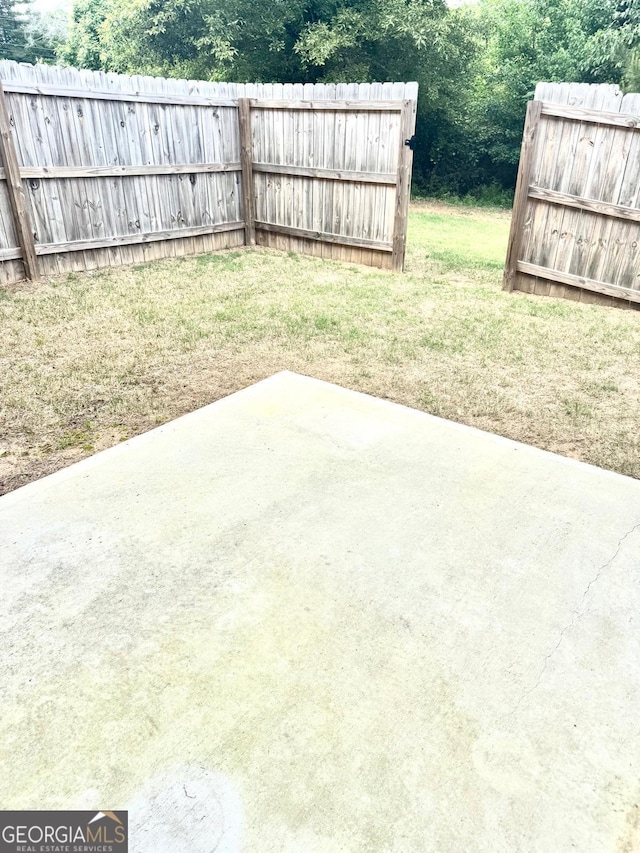 view of yard with fence and a patio area