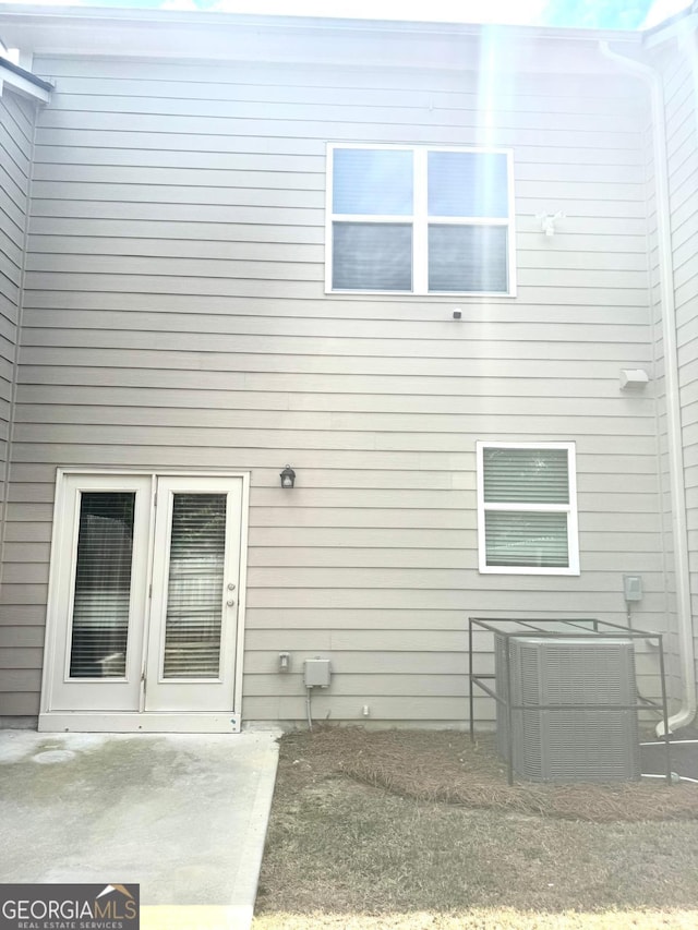 back of house with central AC unit and a patio area