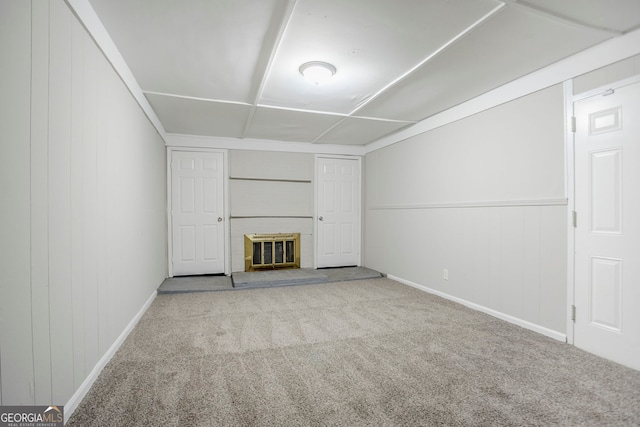 unfurnished living room with a fireplace, carpet, and baseboards