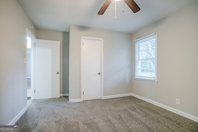 unfurnished bedroom featuring carpet, ceiling fan, and baseboards