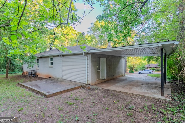 exterior space with an attached carport, brick siding, and central air condition unit