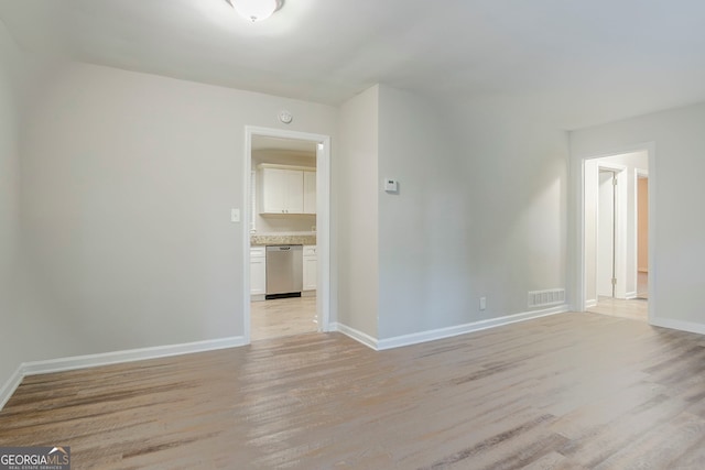 spare room with visible vents, baseboards, and light wood-style floors
