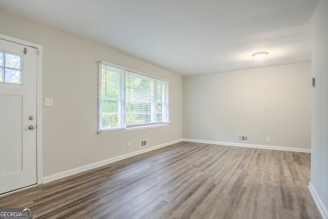 entryway with visible vents, wood finished floors, and baseboards