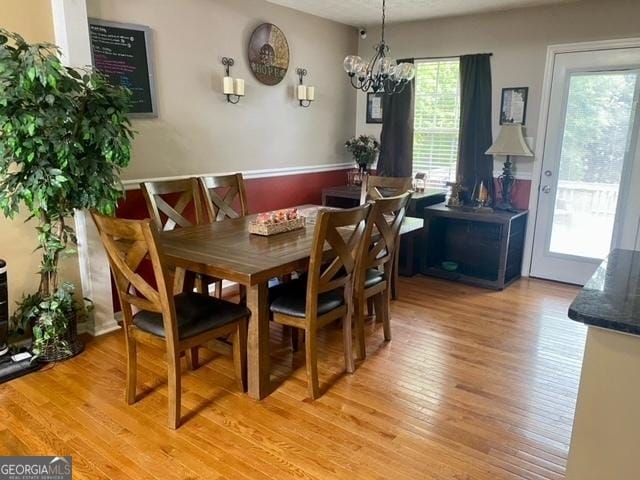 dining room with a notable chandelier and light wood-style flooring