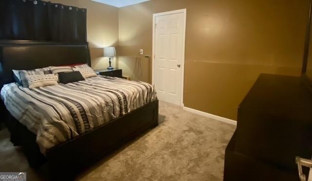bedroom featuring baseboards and carpet floors