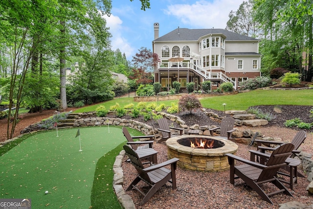 945 Hampton Bluff Dr, Milton, GA 30004 - back of house featuring a lawn, a fire pit, stairs, and a chimney