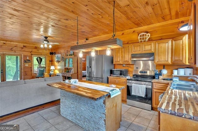 2791 Back Valley Rd, Lyerly, GA 30730 - kitchen featuring a sink, light tile patterned floors, under cabinet range hood, wood counters, and stainless steel appliances