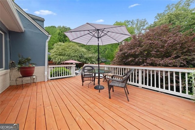 wooden terrace with outdoor dining space