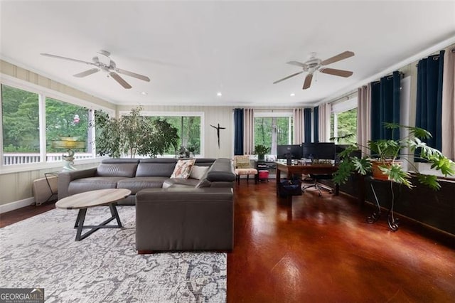 living area featuring wood finished floors, plenty of natural light, and a ceiling fan