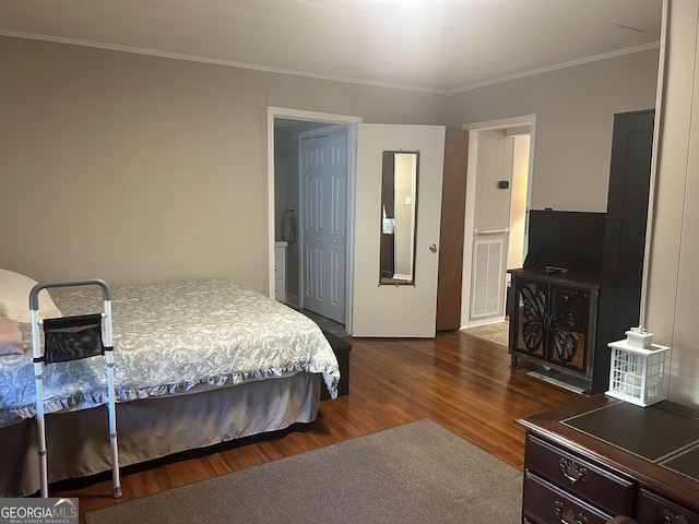bedroom with crown molding, dark wood-style flooring, and visible vents