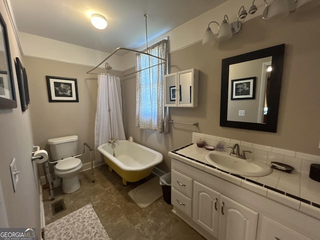 bathroom featuring vanity, toilet, visible vents, and baseboards