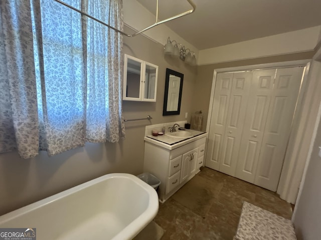 bathroom with vanity and a freestanding bath